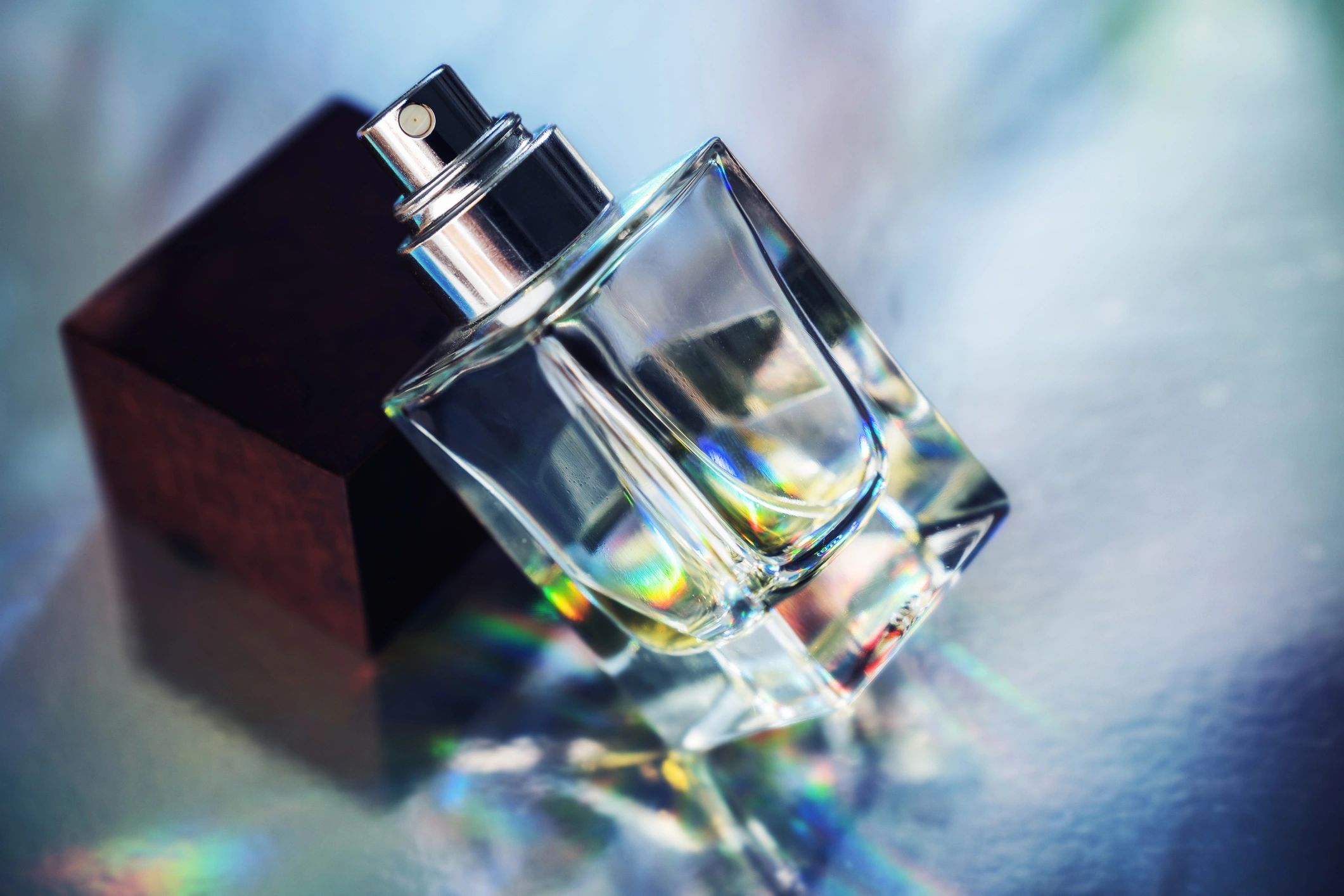 Close-up perfume bottle with reflective light