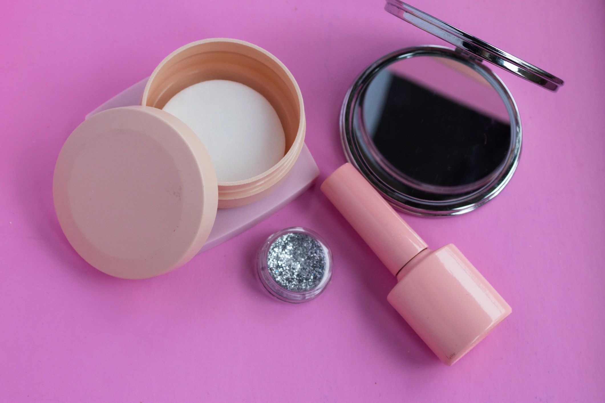 Beauty accessories and cosmetics on pink background